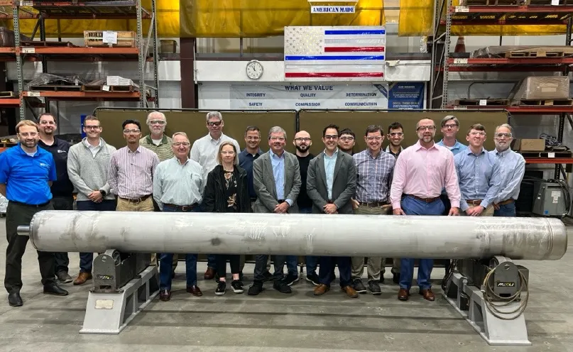 Attendees of the workshop photographed with the Universal Canister System mockup. 